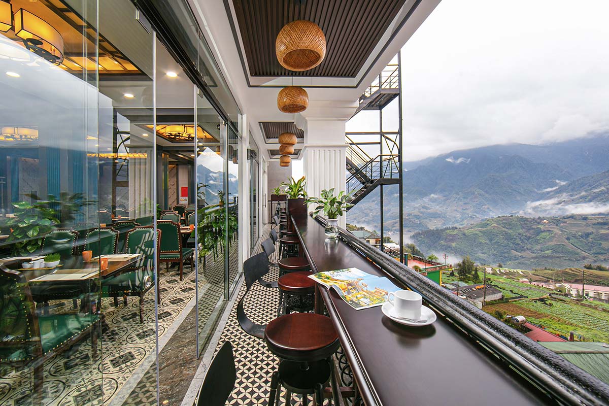 Terrace at DeLaSol Phat Linh Hotel Sapa with bar seating and mountain panorama